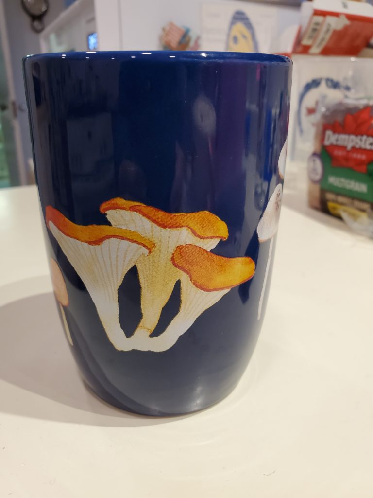 Blue mug with mushrooms on it.